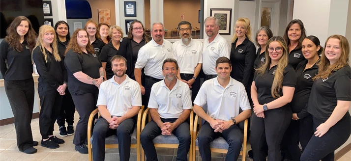 The Doctors and team from Advanced Back and Neck Care Center taking a team photo in the lobby