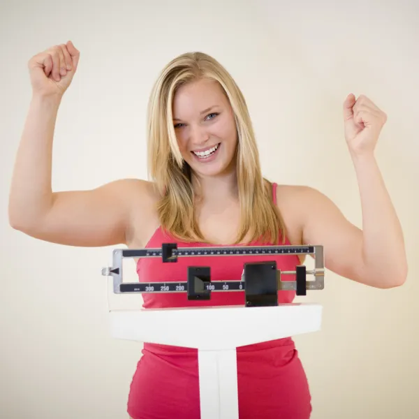 Chiropractic Groton CT Woman Celebrating Weigh In on Scale